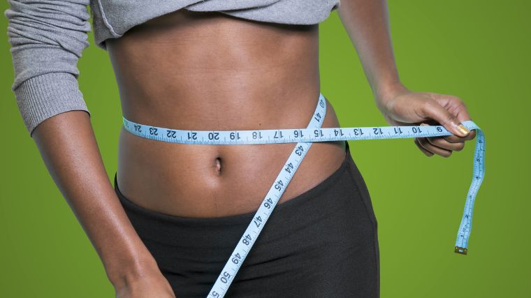 A person checking their waist measurement.